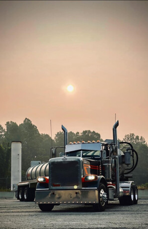 Titan water truck head-on in hazy morning sun